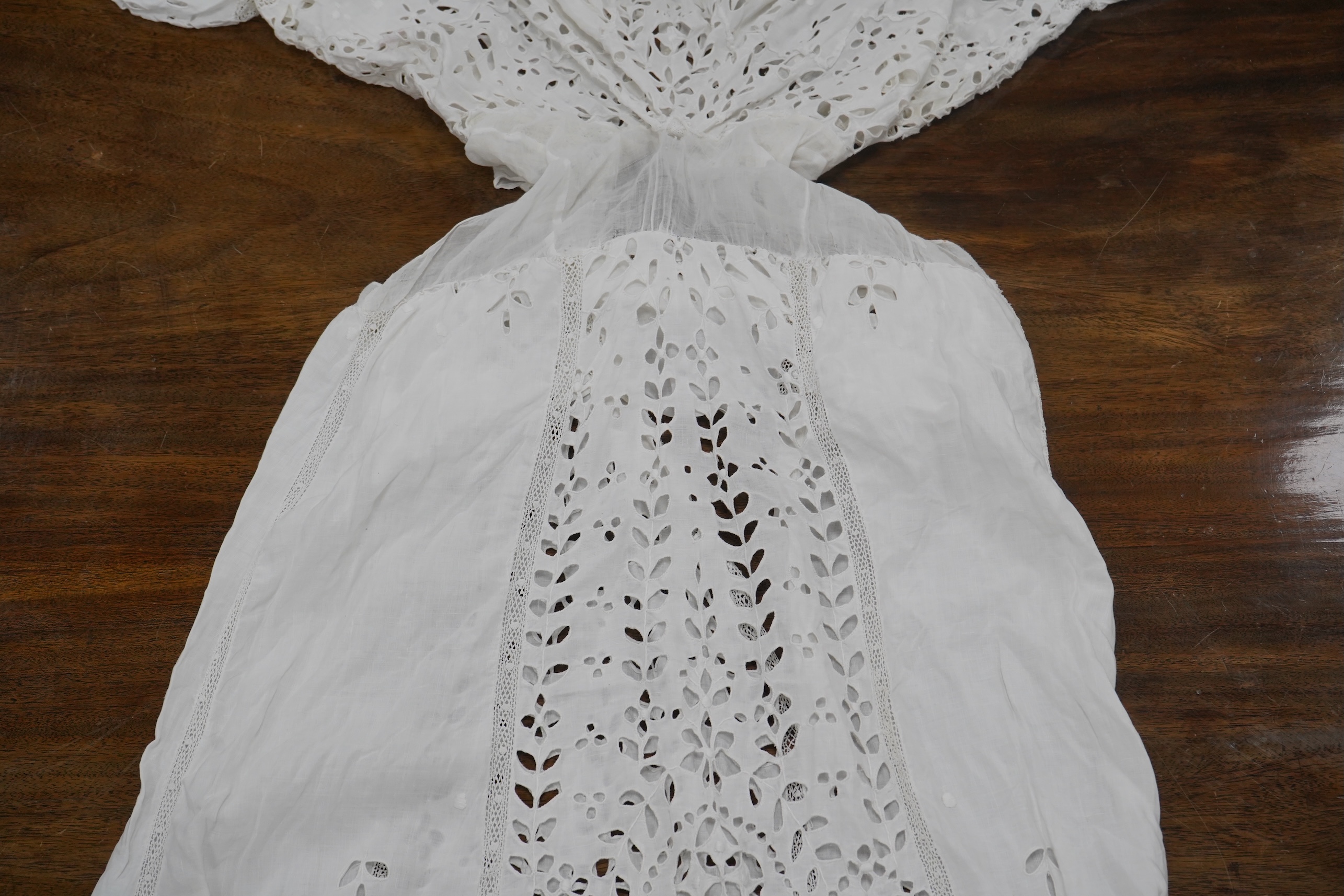 An Edwardian fine white embroidery anglaise and Irish crochet trimmed ladies summer dress, designed with large panels of anglaise cut work, the dress has been altered and restyled, which could be altered back, 134cm long